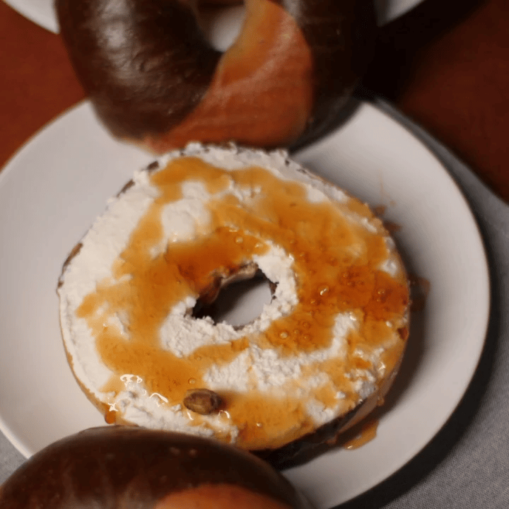 marble rye bagel with cream cheese and honey