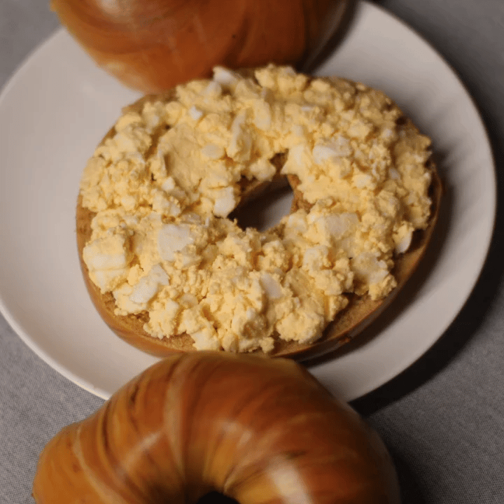french toast bagel with scrambled eggs and bacon